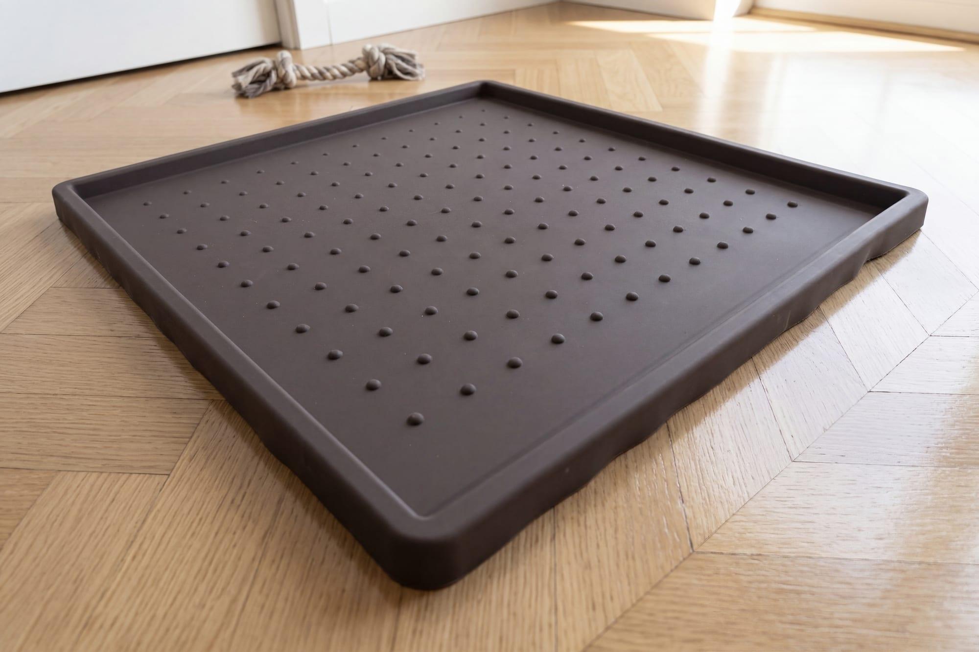 The FloorMate holding a Pee Pad flat and secure during a training reset